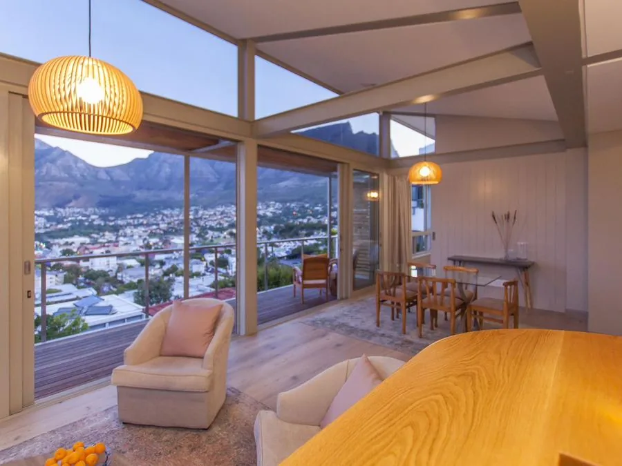 Living and dining room opening onto a balcony with mountain views, Lion's Head and Fresnaye